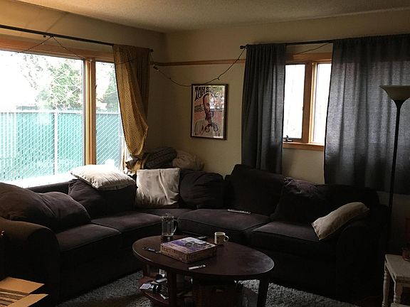 Living room with hardwood floors, wood trim and high quality, double-paned windows.