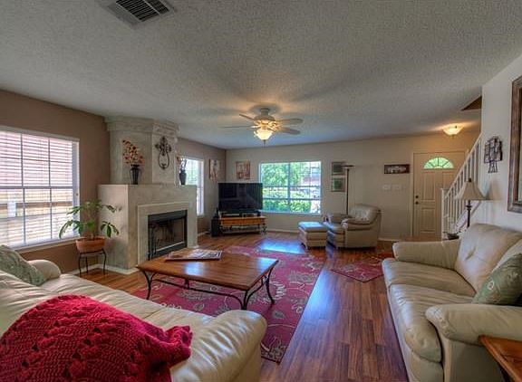 The living room features a central fireplace.