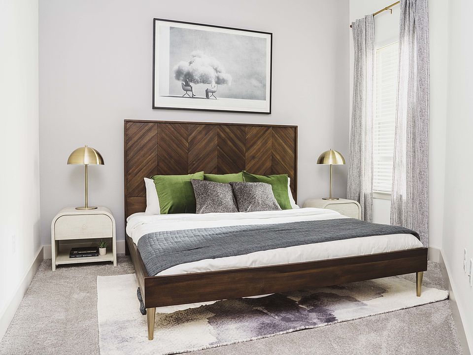 Spacious bedroom with plush carpet and large windows