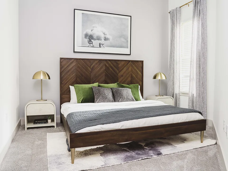 Spacious bedroom with plush carpet and large windows