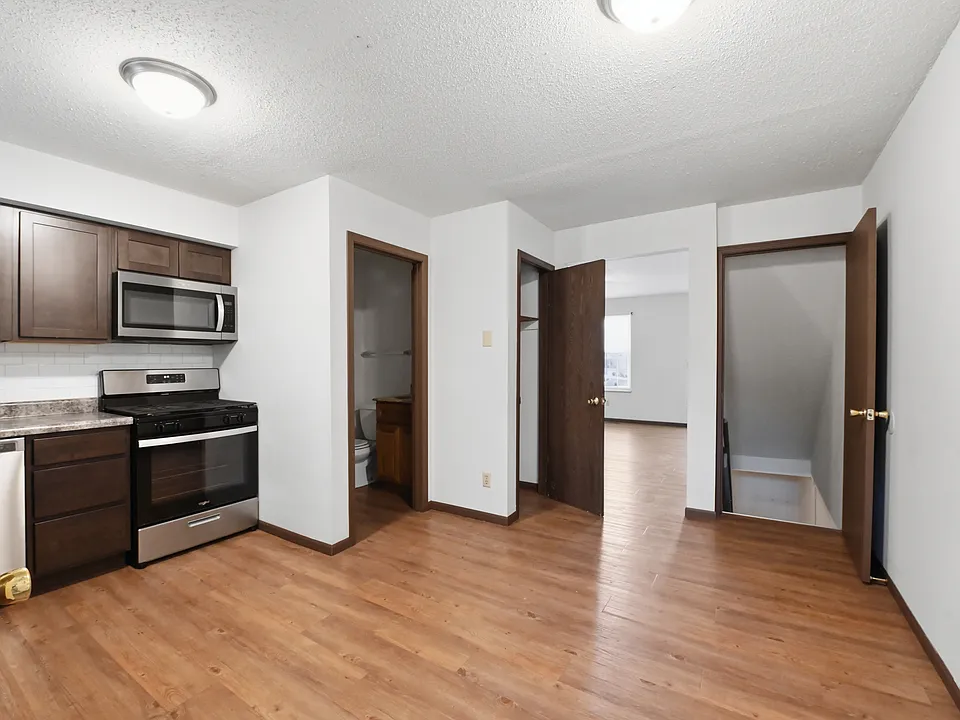 This is the kitchen looking into the living room with the basement door to the right.