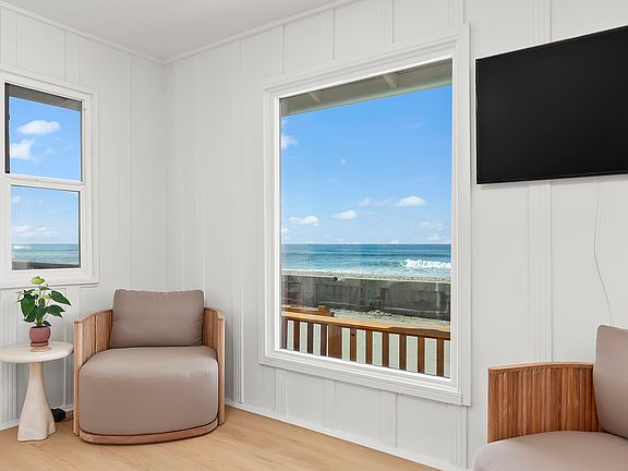 Cozy seating area with direct views of the beach. The perfect spot for morning coffee or an evening glass of wine.