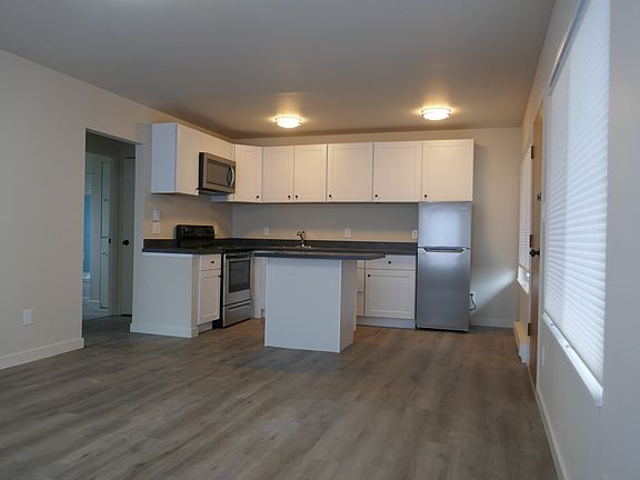 Beautiful open floor plan from kitchen to living room with big open windows letting in tons of natural light