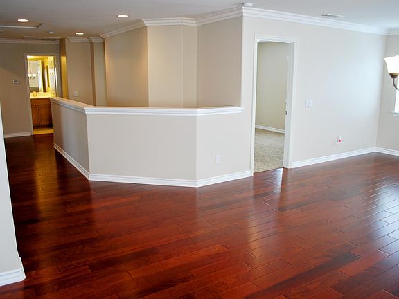 Upstairs bonus room with hardwood flooring