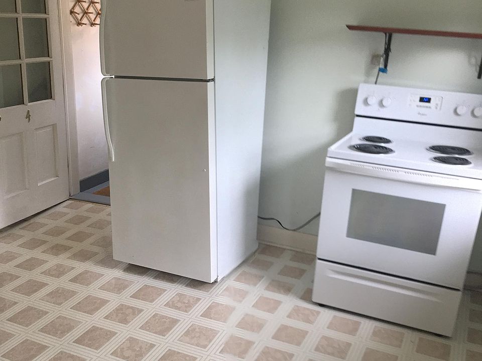 Kitchen with Electric stove, and back exit to parking lot