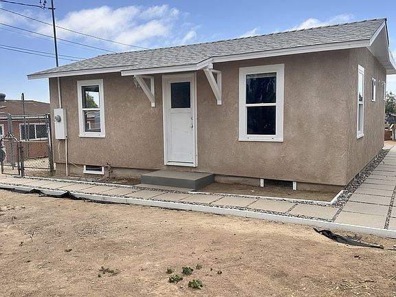 Front of the house. New windows, walkway, and door.