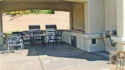 Common area party barbeque and sitting area by pool
