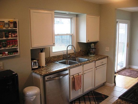 Additional counter spaces w window over sink overlooking fenced back yard.