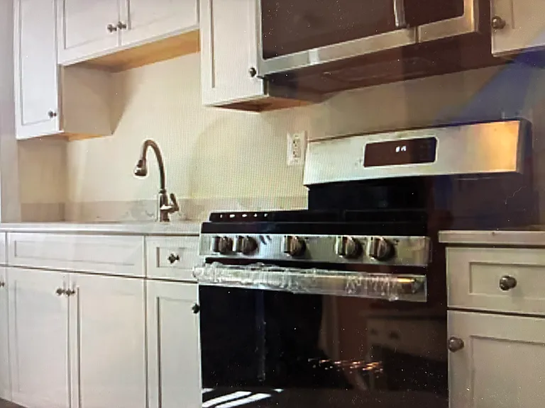 This spacious gourmet kitchen has a large stainless steel sink and appliances.