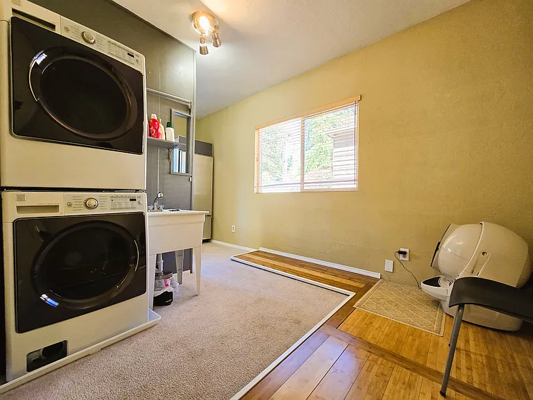 Light filled laundry area with functional utility sink.