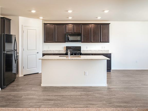 Spacious kitchen area, with an attached space for dining.