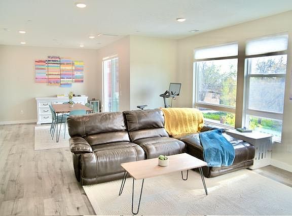 Open layout kitchen, living, and dining room with sweeping views and large windows