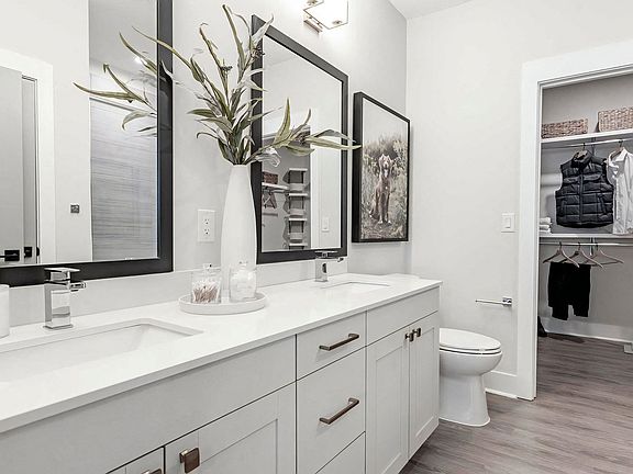 Luxurious bathroom with double vanity and spacious walk-in closet