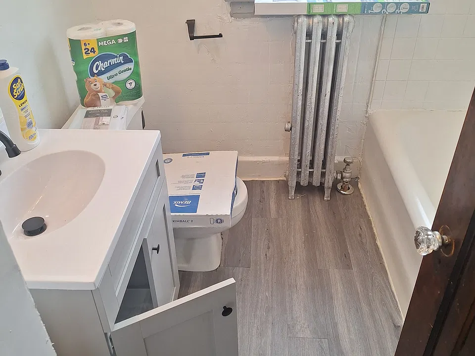 Bathroom entrance from the hallway. 
New vanity, flooring and paint.
