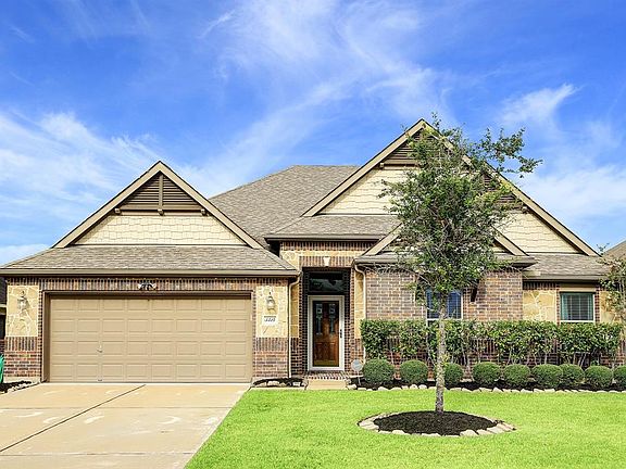 The exterior is as beautiful as the inside. You'll love the brick and shaker style shingles with stone accents, a covered front entry, handsome carriage lighting, and a massive covered patio in the back.