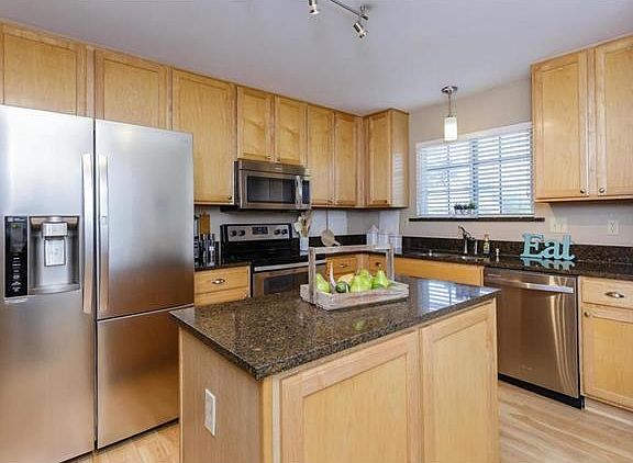 Kitchen features 42" maple cabinets, granite counters and stainless appliance package.