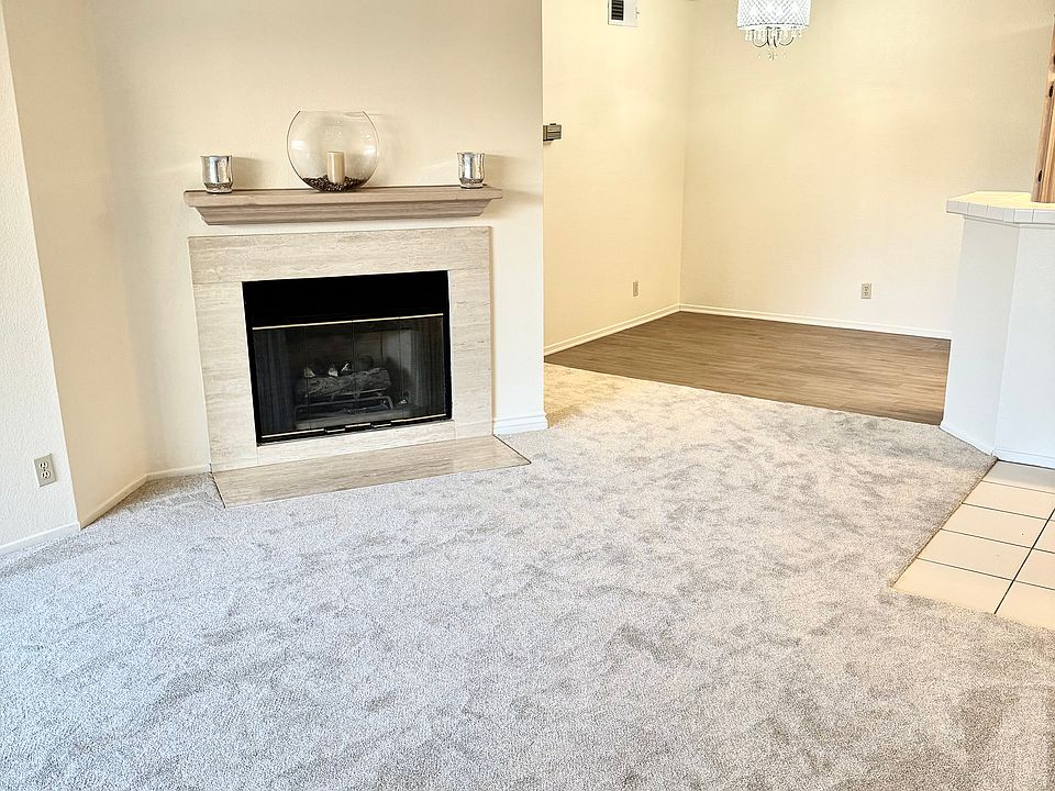 Living room with fireplace and dining room area