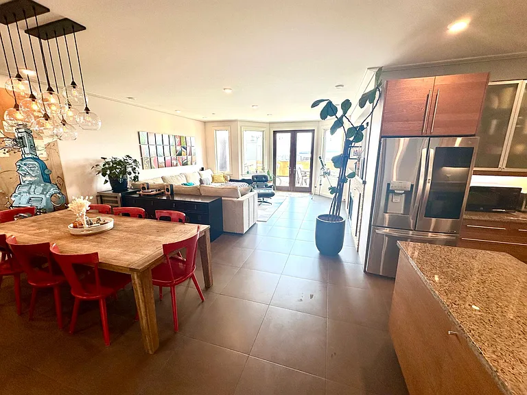 View from hallway facing great room and kitchen
