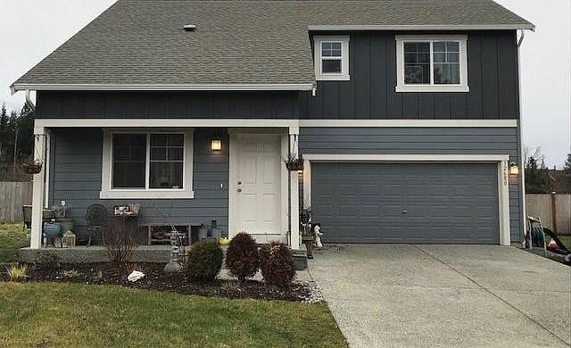 Exterior showing large driveway for multiple cars.