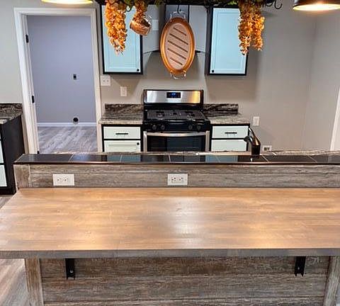 Kitchen with a fold away breakfast bar & pot rack