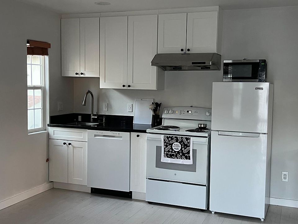 Fully equipped kitchen with full size refrigerator, dishwasher, 4 burner electric range, microwave.