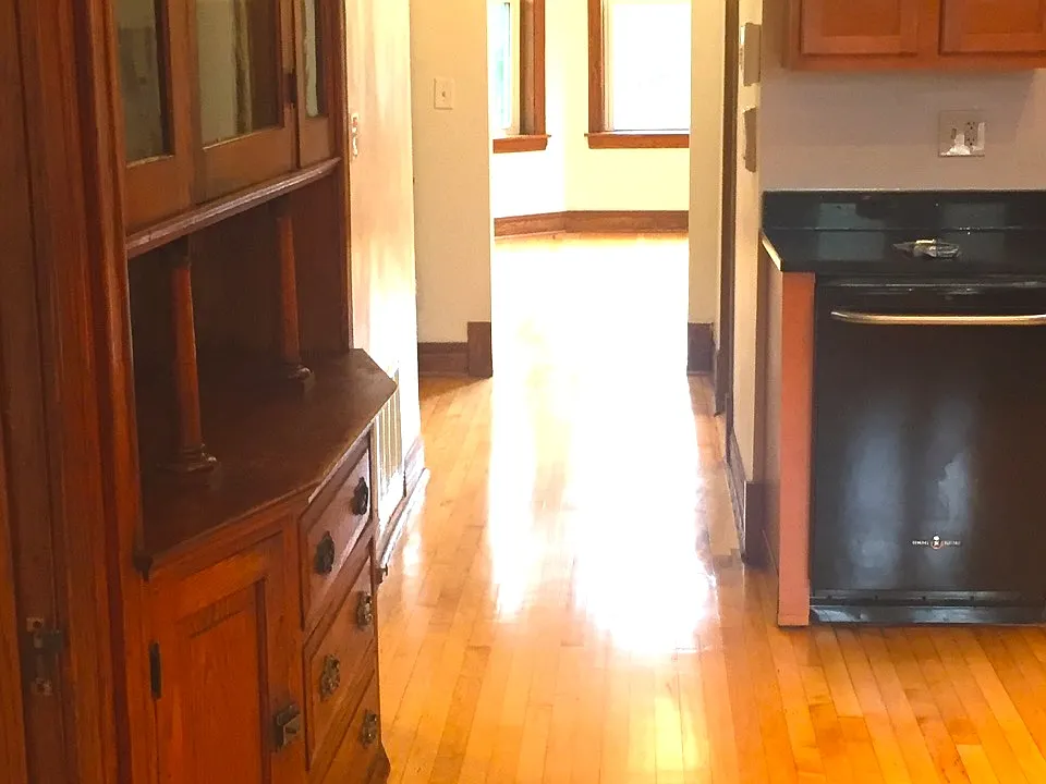 Central corridor and bay windows provide light and warmth throughout the unit.