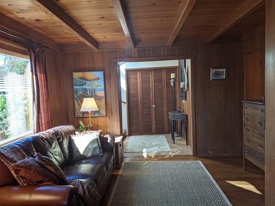 Den leading to stairs to second story