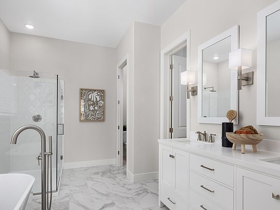 Primary suite with freestanding vanity and freestanding tub