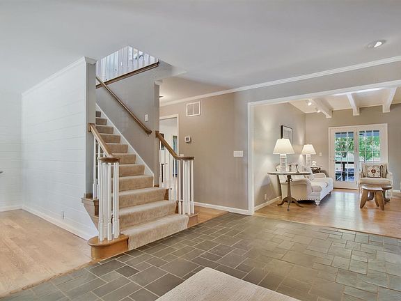 Open and spacious entryway that leads to dining room and living room. Look at those French doors!