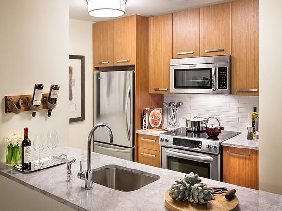 Walnut cabinetry, Italian marble countertops, and stainless steel appliances are just a few of the m