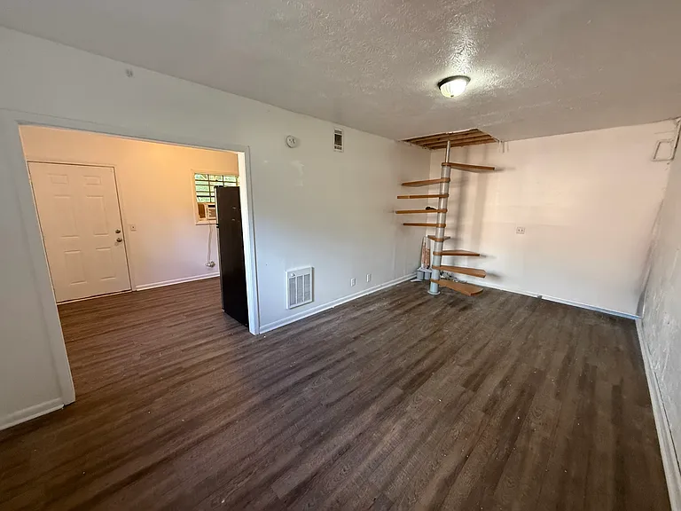 The lower level features a separate studio-style suite with its own full bathroom, kitchenette, and private entrance ideal for a guest suite, home office, or bonus living space.