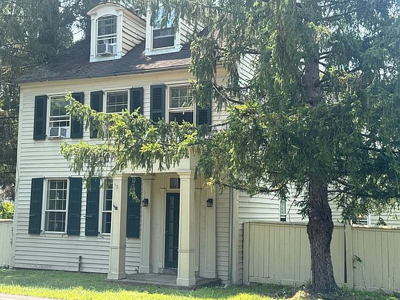 Front view of house facing road with partial view of right side (not viewing left side of house).