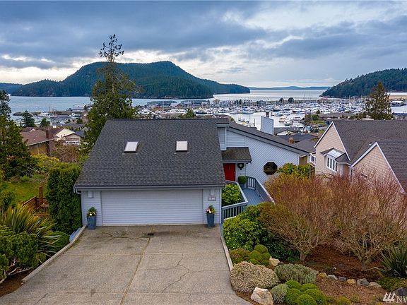 Street front view of this gorgeous Skyline home with beautiful mature landscaping, lush grounds, garden plot and of course the views await!
