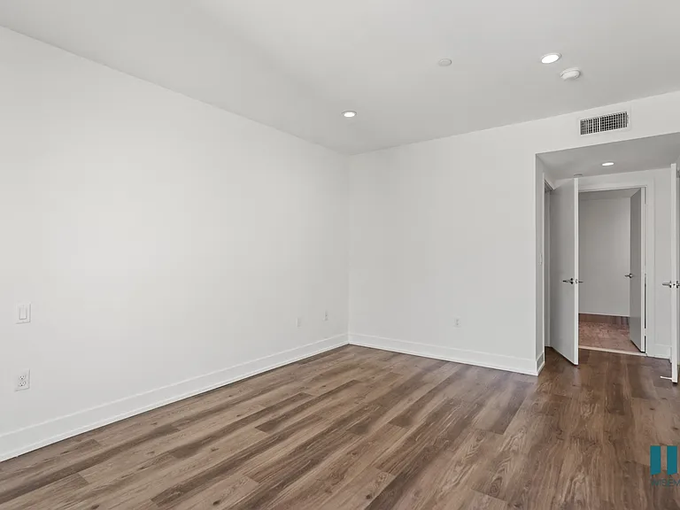 Bedroom with Vinyl Flooring, Recessed Lighting, and Bathroom