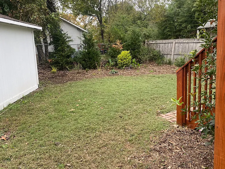 Garage located to the left. Showing backyard and deck
