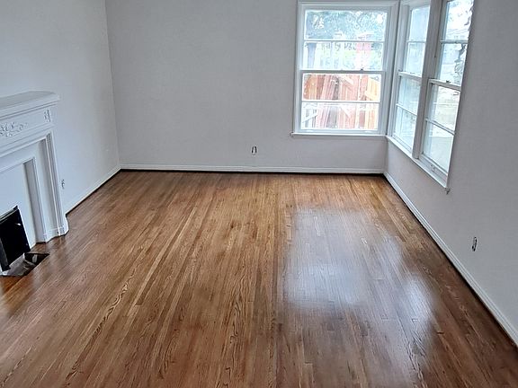 Living room with faux fire place heater, New hardwood floors oak, will have window ac unit with wifi access. Size is 12'x18' sq feet. 

Here is walk through video of the unit: