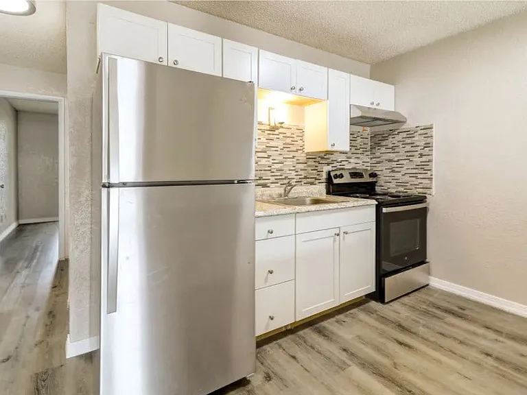 Modern kitchen with sleek stainless steel appliances, elegant marble countertops, and stylish tile backsplash. Modern kitchen with sleek stainless steel appliances, elegant marble countertops, and stylish tile backsplash.