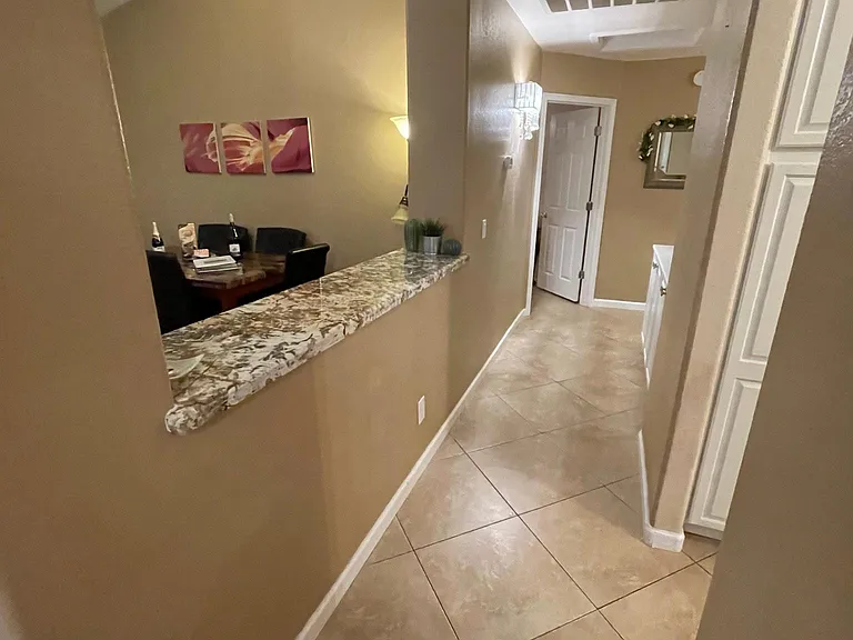 Hallway with granite counter accent top nice addition and great place to serve snacks/food!