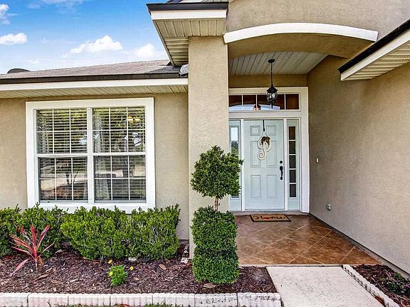 Deep covered entry way with hanging carriage light.
