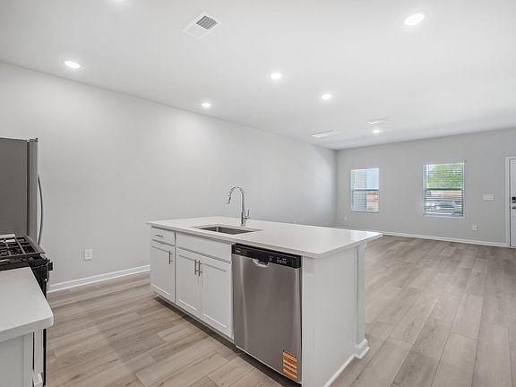 A sizeable kitchen island overlooks the sprawling great room.