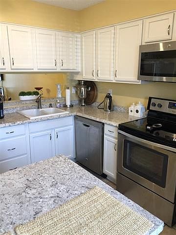 Wonderful updated kitchen with stainless appliances including smooth cooktop stove, dishwasher, microwave, and refrigerator
