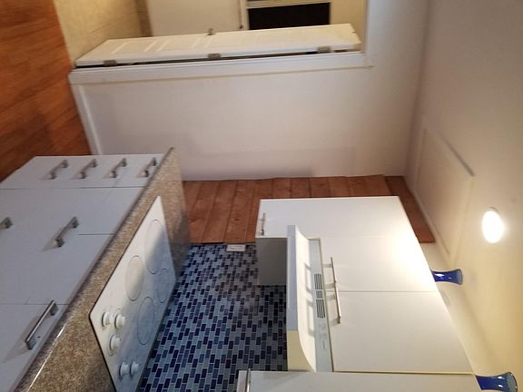 large kitchen with microwave and refrigrator