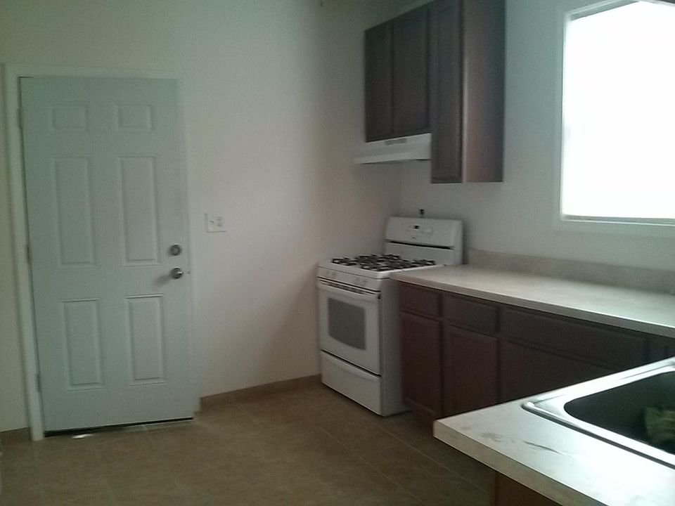 Kitchen with back entrance, with custom maple cabinets