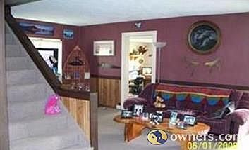 view from kitchen archway to LR showing door into den and stairw