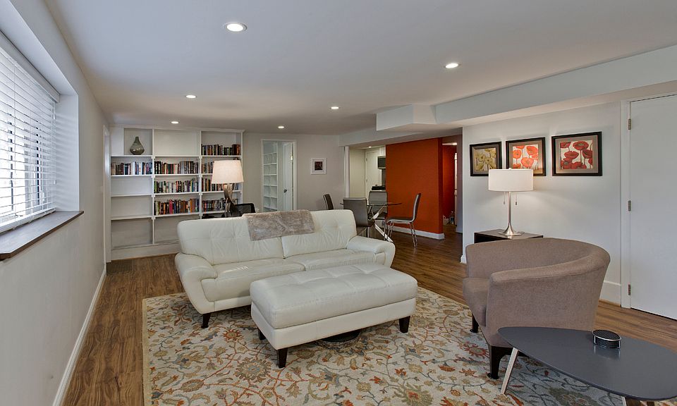 Living room view toward bookshelves, dining area