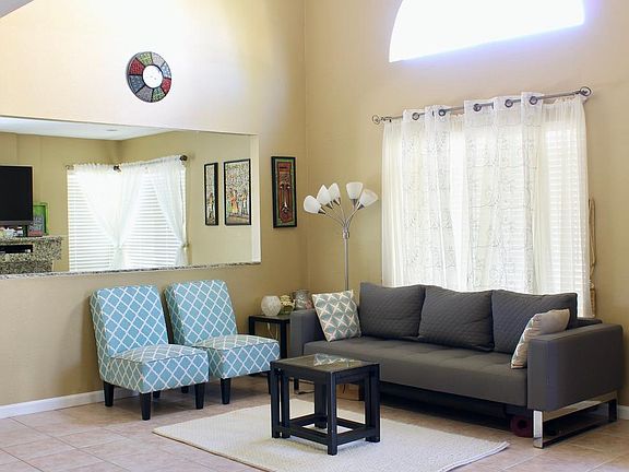 Formal living room with family room visible in the background