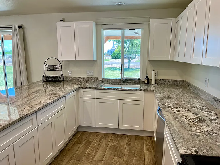 Brand new Farm style open galley kitchen. New granite counters, sink and faucet.