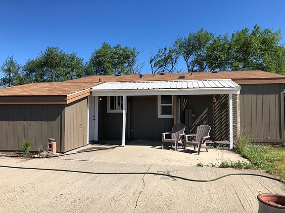 Partially covered large patio and side entry door into mud room