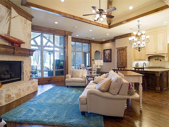 Great room is open to kitchen and breakfast rooms.  Beautiful views of the covered patio and outdoor living area.