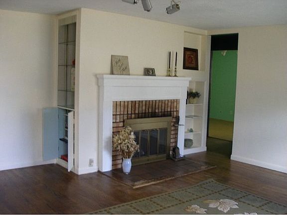 Wood burning fireplace with attractive mantel and book case